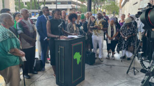 Hands Off Uhuru! Campaign Chair Mwezi Odom speaks at the press conference on day one of the trial of the Uhuru 3, outside the Federal Courthouse in Tampa, Florida